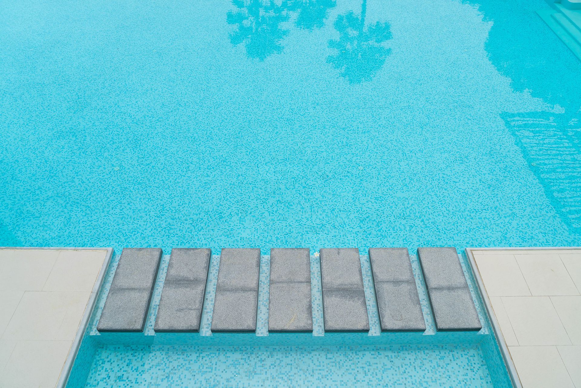 A swimming pool with a row of steps leading into it.