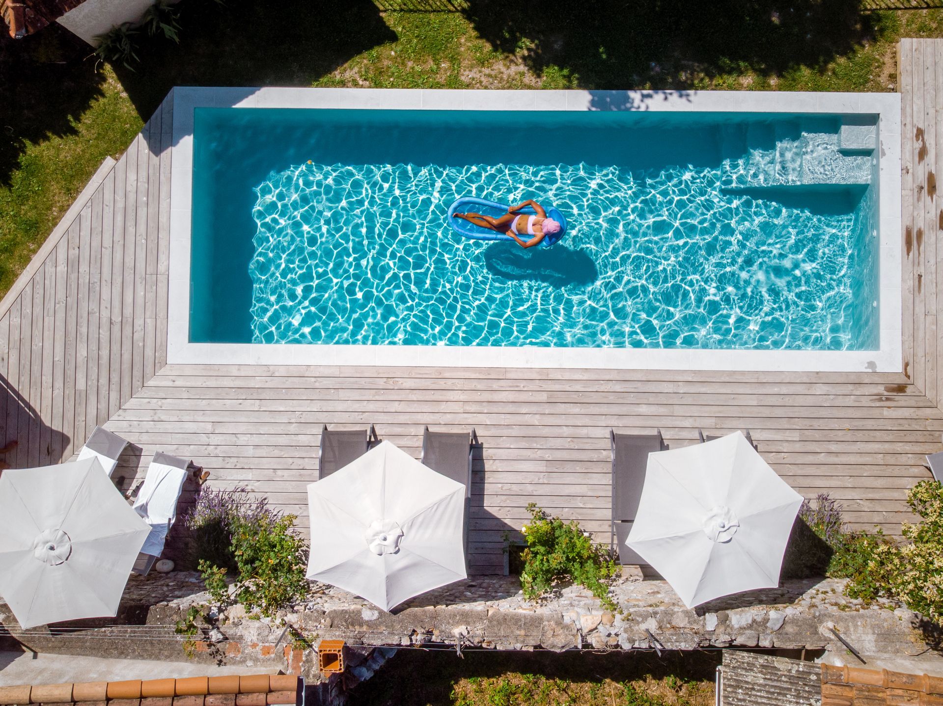 A jet is spraying water into a swimming pool.