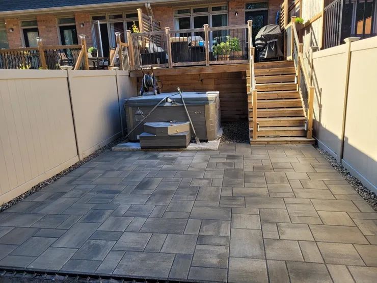 There is a hot tub in the backyard of a house.