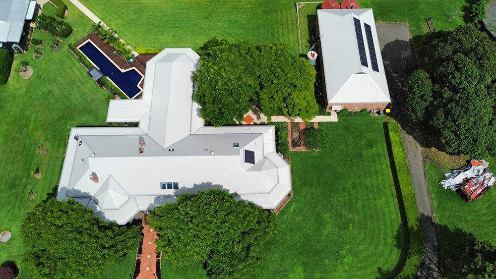An Aerial View of a Large House With a Pool in the Backyard โ Tim Leach Metal Roofing in Wauchope, NSW