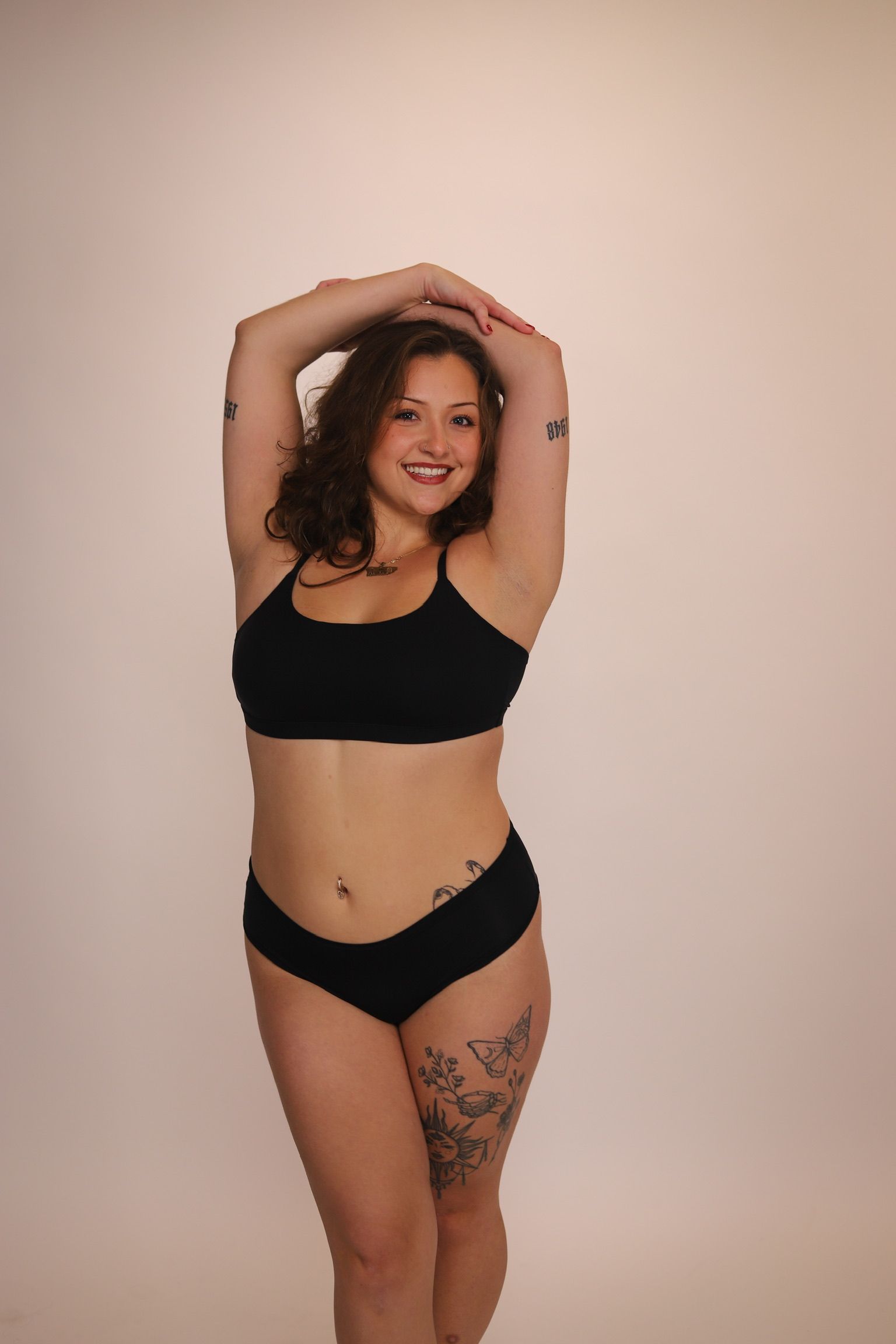Person in beige underwear lying down, hands on hip, well-defined abdominal muscles visible.