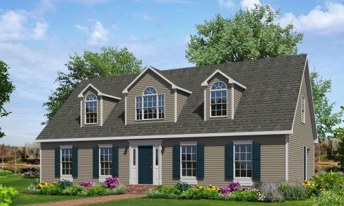 Two-story gray house with dormer windows, white trim, and a flower-lined front yard under a blue sky