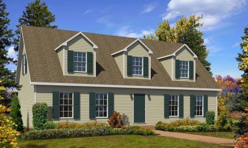 Suburban house with beige siding, green shutters, dormer windows, and a manicured lawn under a blue sky