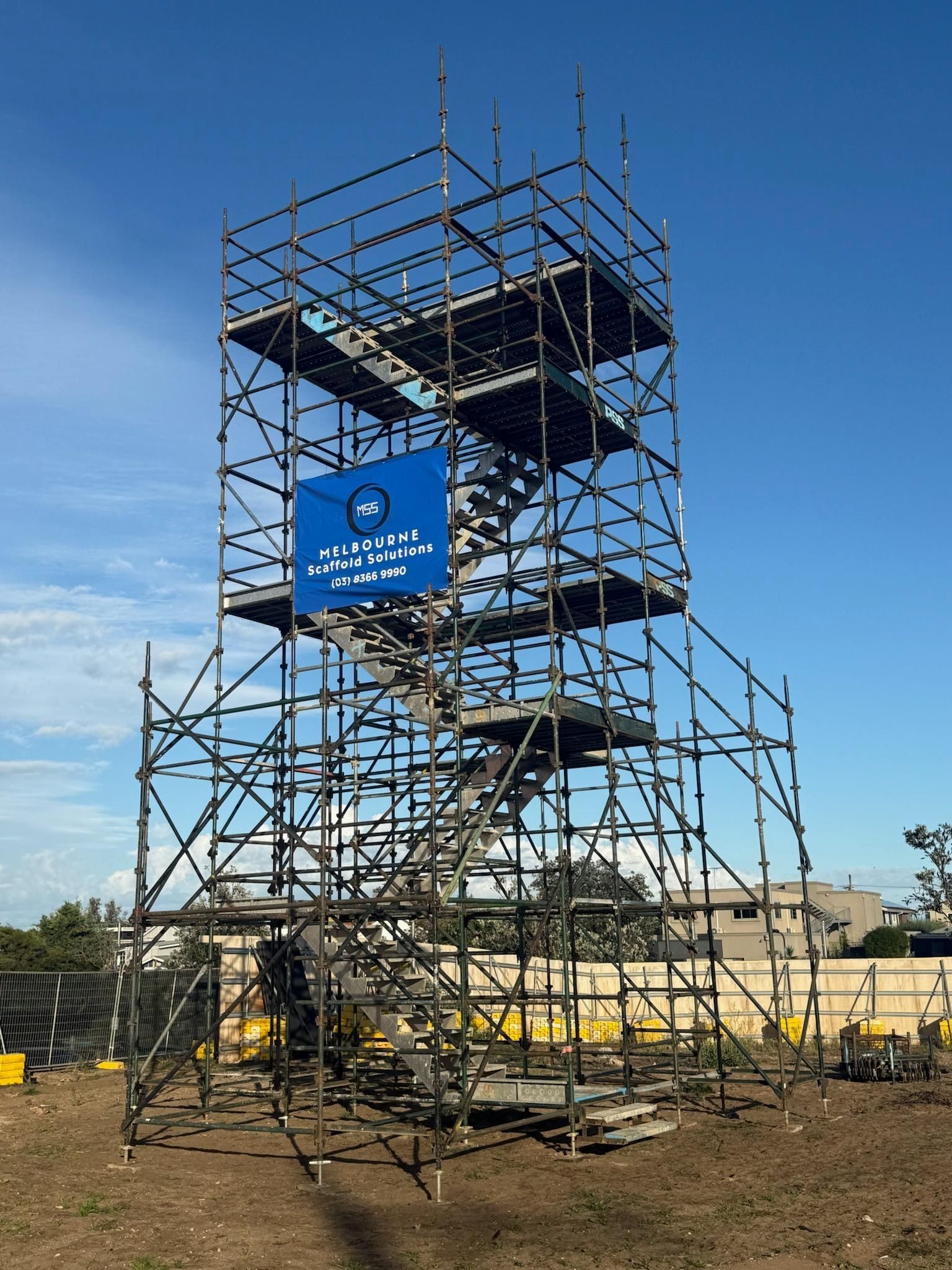 Scaffolding against a bright blue sky.