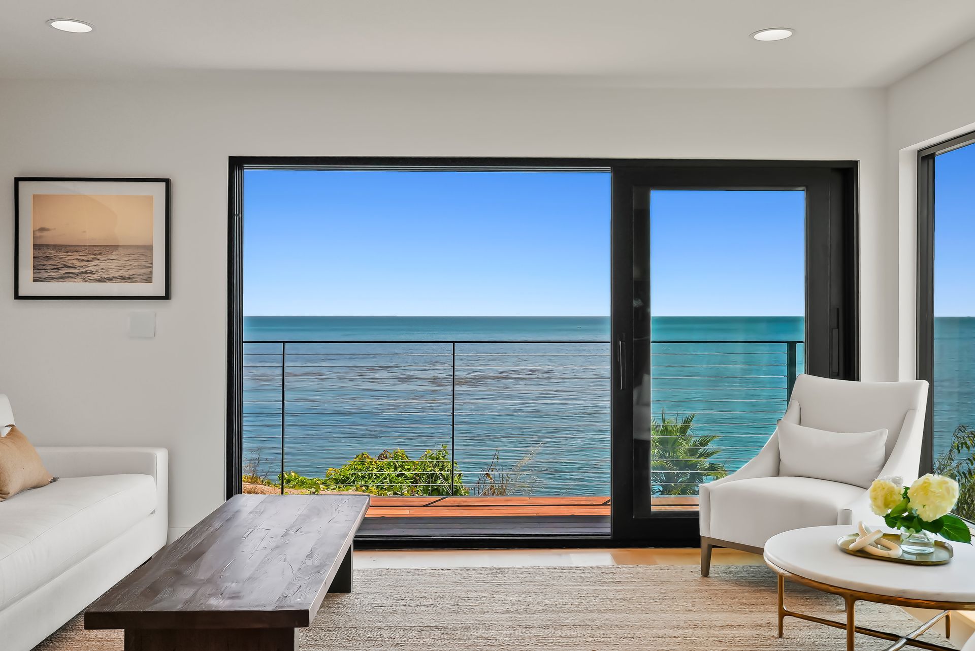 Modern living room with ocean view through large sliding glass doors