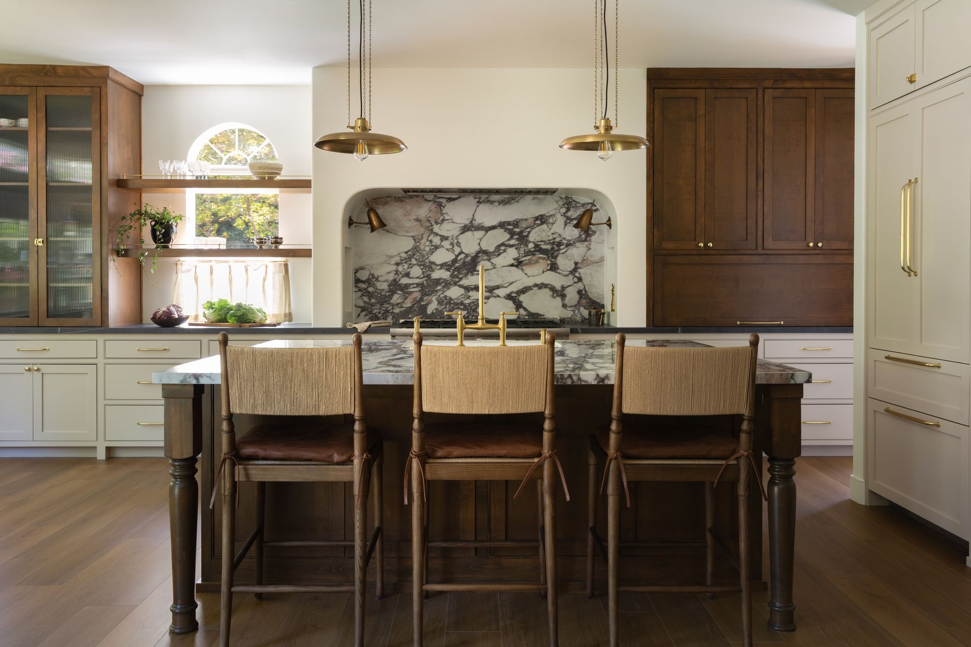 Luxury kitchen renovation that hosts a polished stone backdrop and kitchen island.