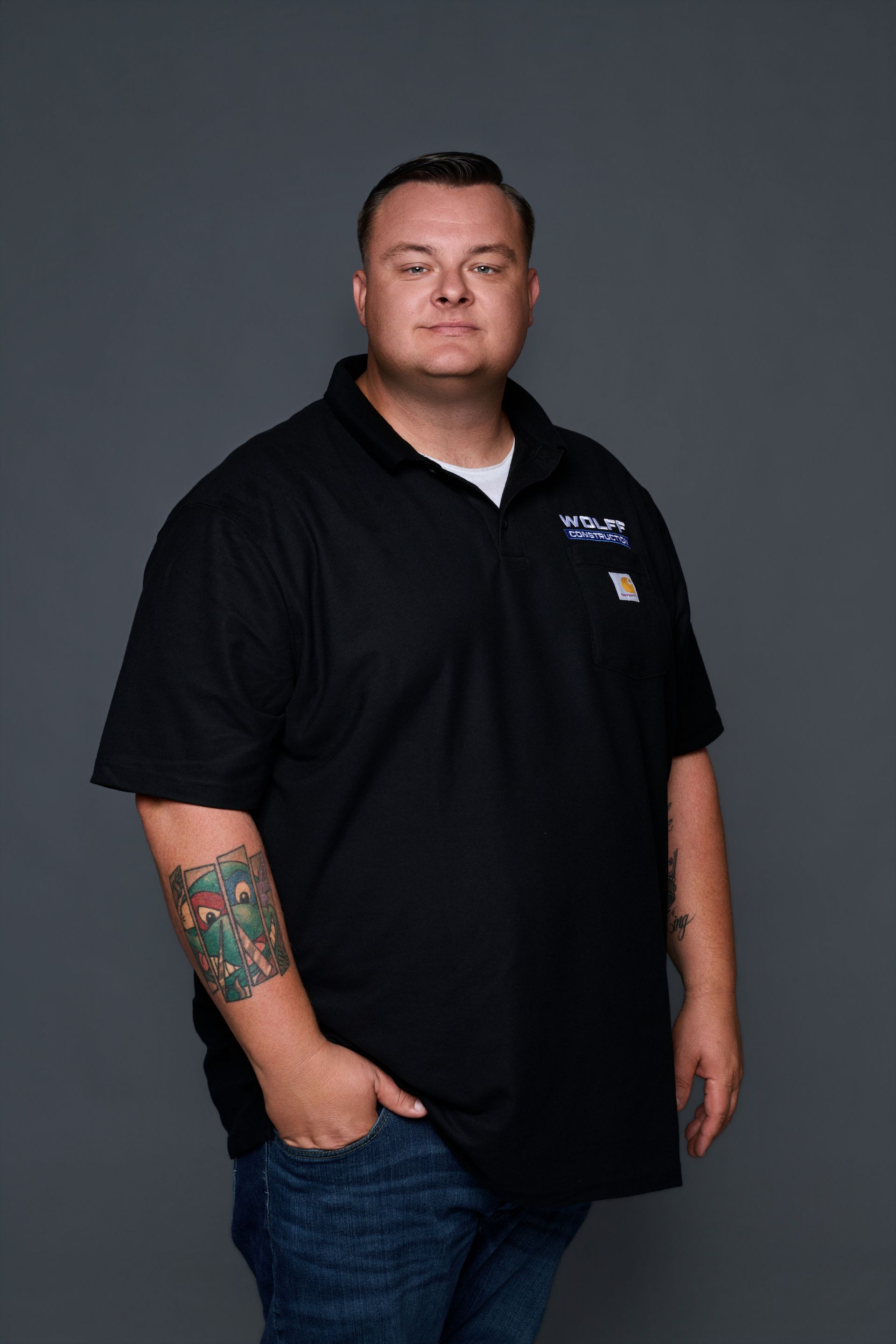 Headshot of Jared Schneider, Lead Project Manager at Wolff Construction, in a black polo and cap.