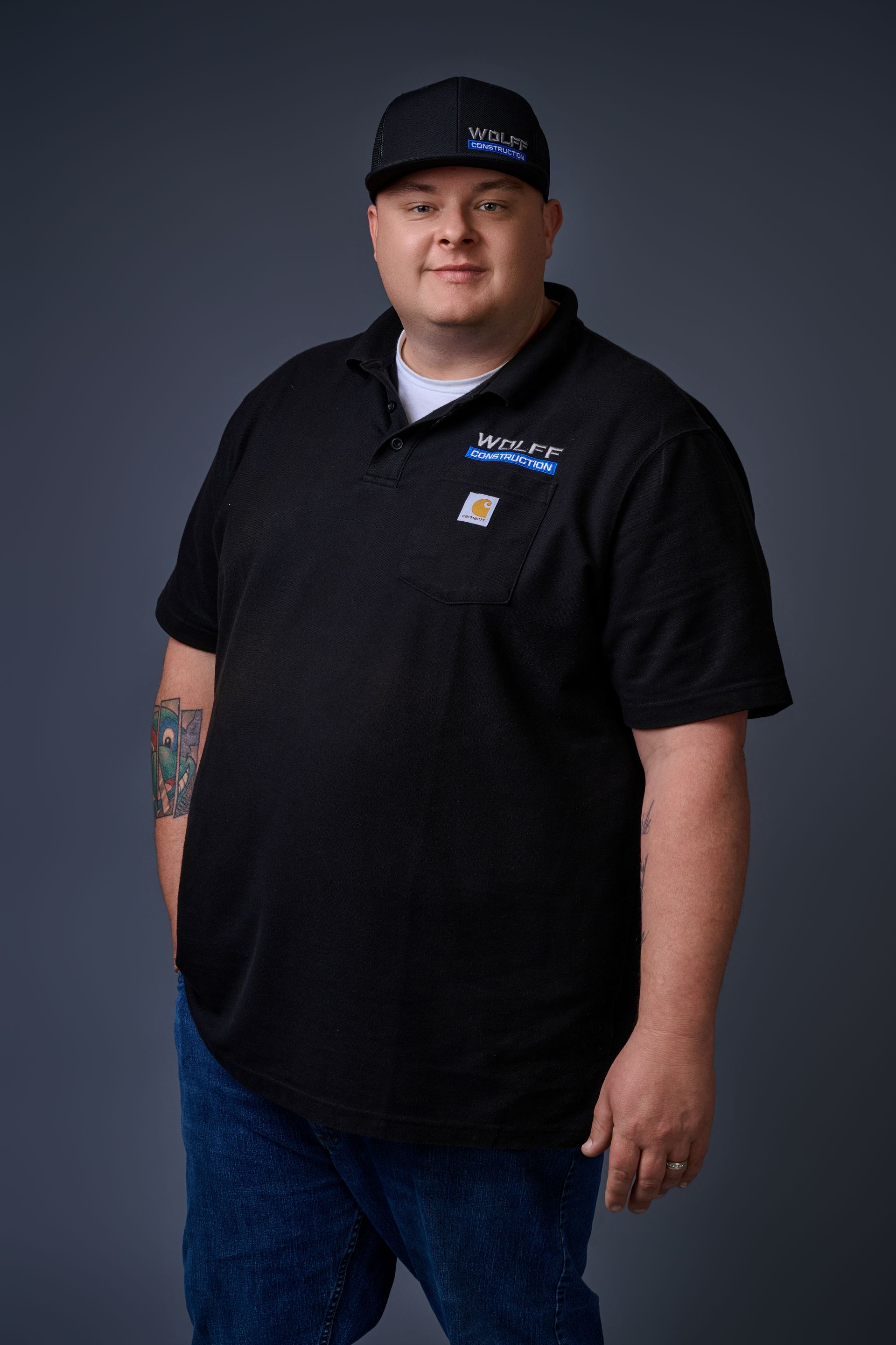 Headshot of Jared Schneider, Lead Project Manager at Wolff Construction, in a black polo and cap.