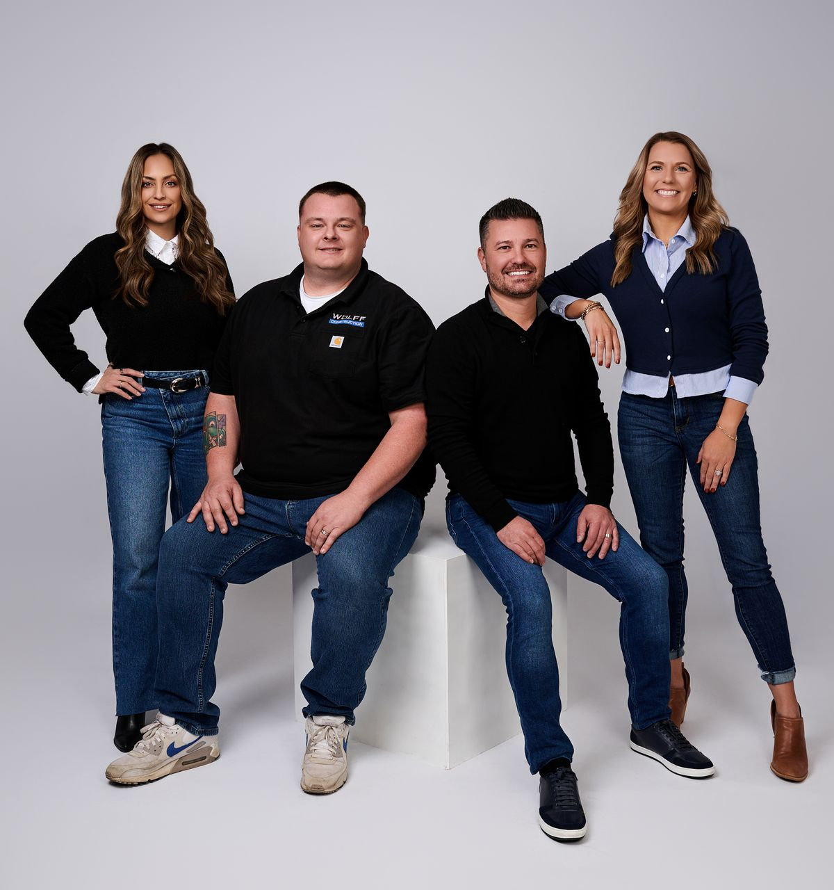 Wolff Construction team posing together in a professional studio setting.