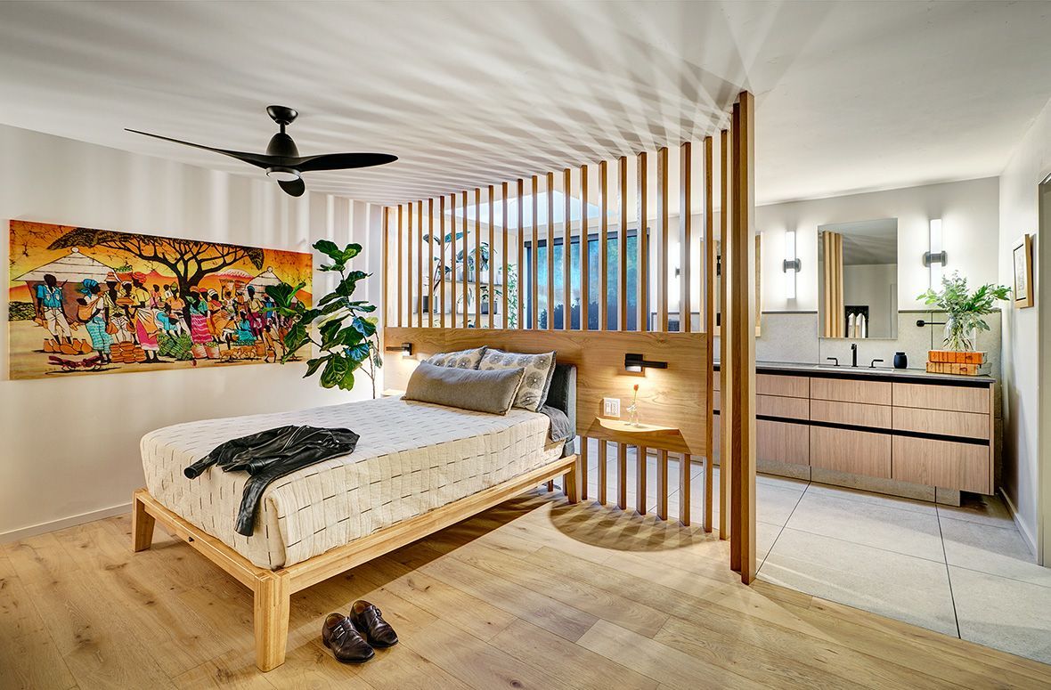 Bedroom with a wood-frame bed, ceiling fan, and natural light.