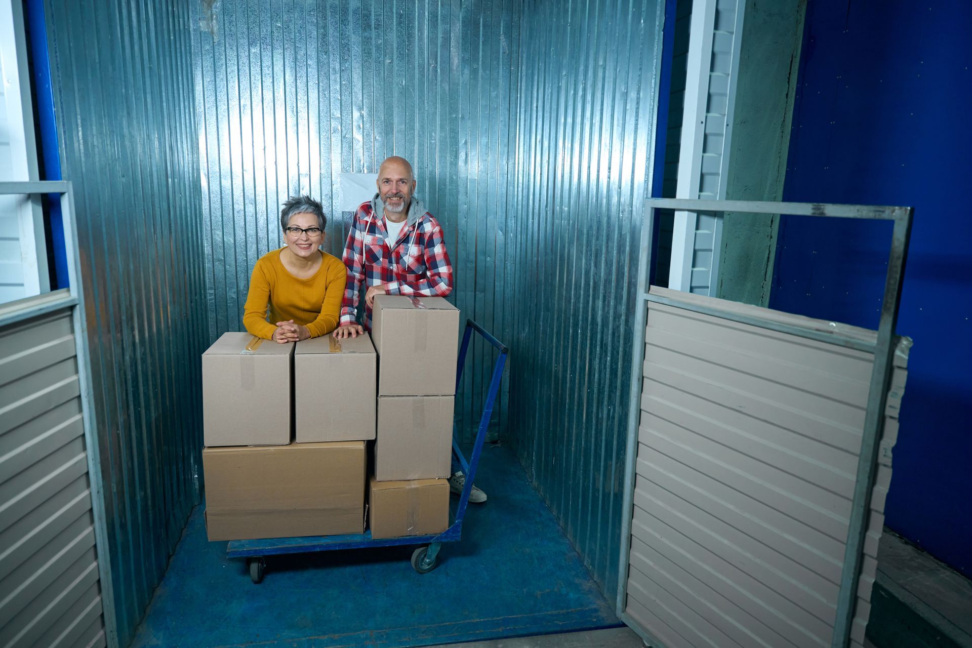 Best storage units in Anderson, SC with customers moving boxes into a clean, secure storage unit