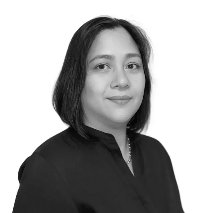 Woman with dark hair wearing a black shirt, smiling, looking at the camera.