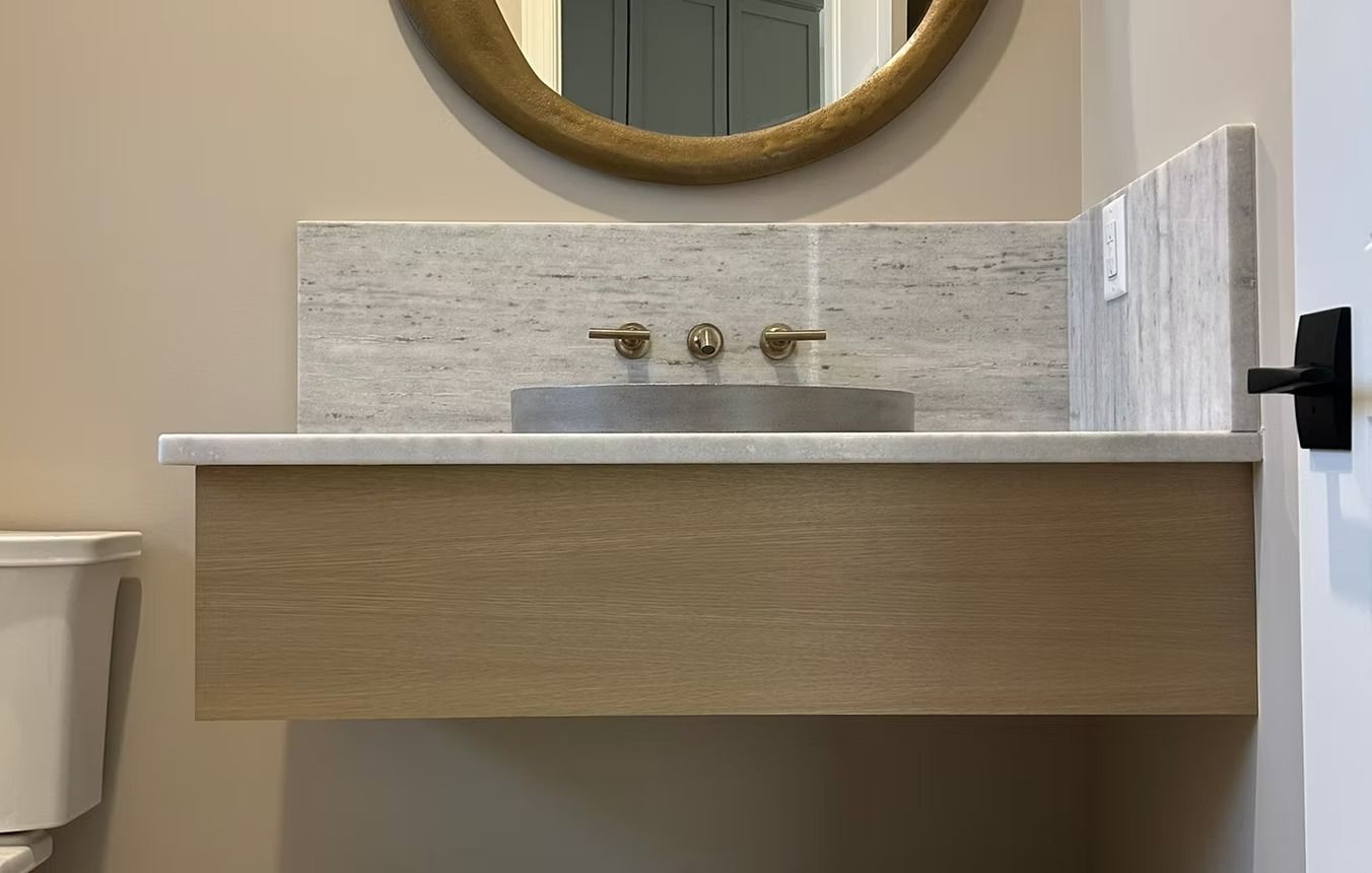Modern bathroom vanity with sink, mirror, and beige tiled backsplash