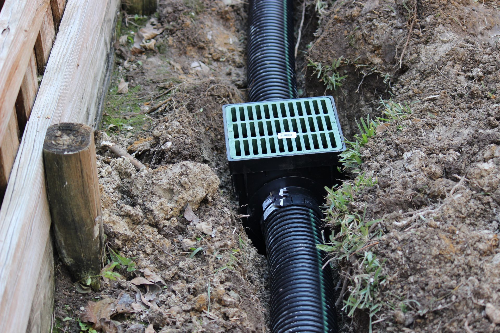 A concrete pipe is being installed in the dirt.
