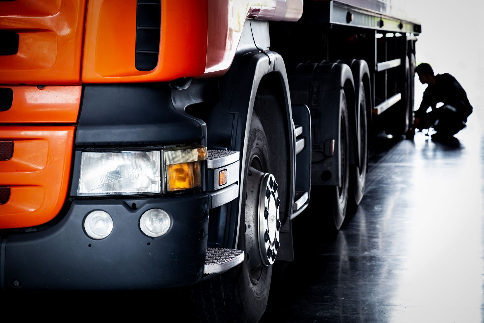 Close-up of a freight truck during routine maintenance and safety compliance checks.