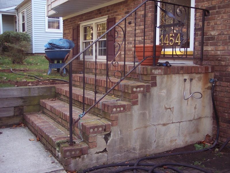 Brick front steps with black railings leading to a house entrance, with house number 1454 visible.