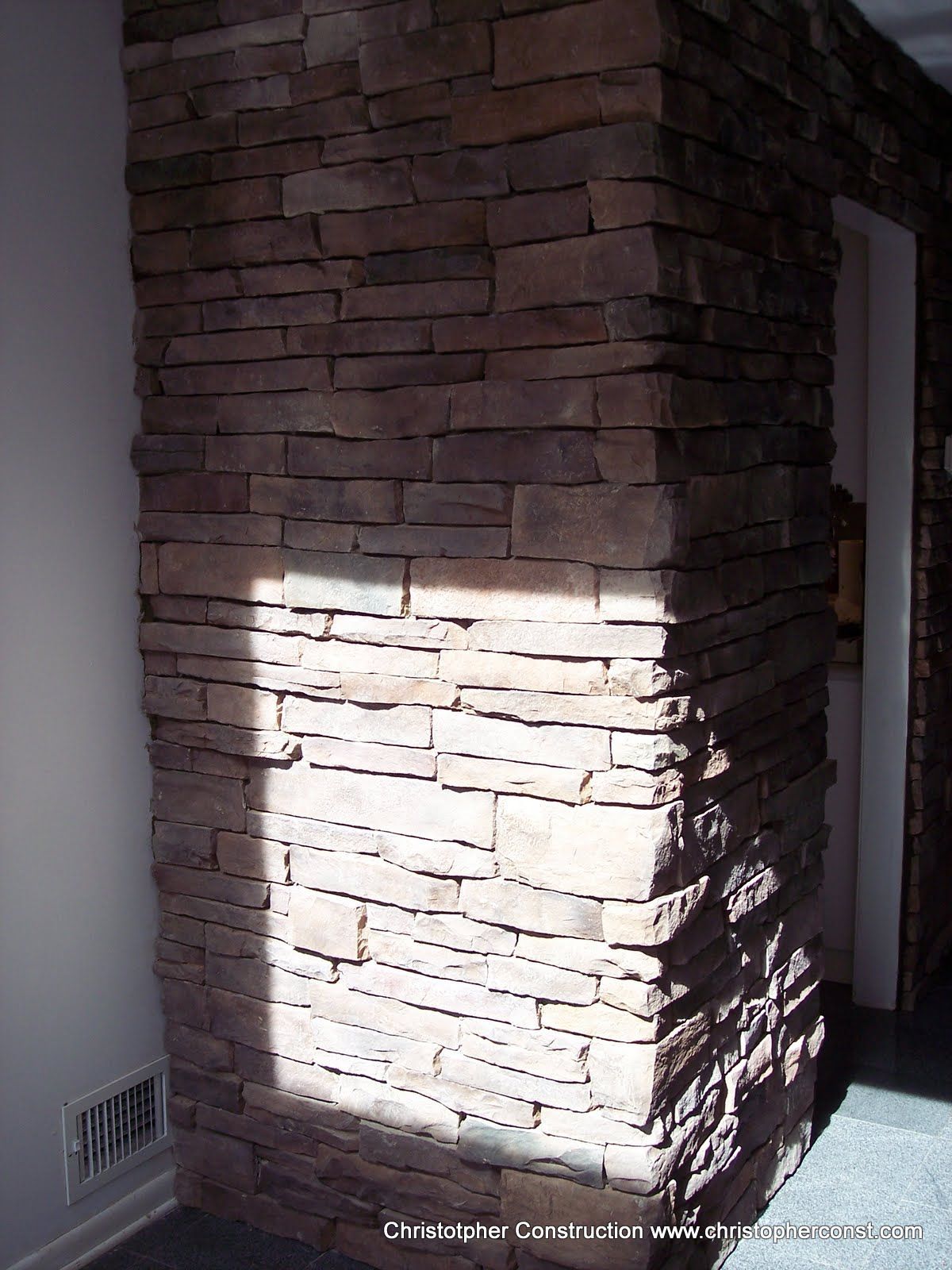 Stone column with a bright patch of sunlight indoors