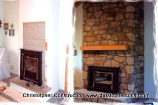Two fireplaces in a room, one brick and one stone, with a wooden mantel and white walls