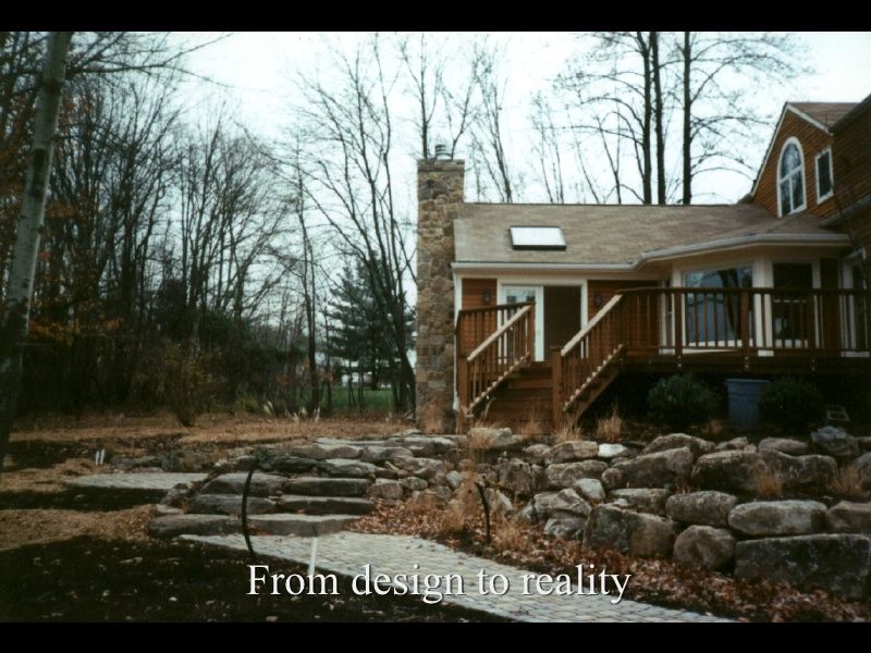 Brick house with porch and stone steps beside bare trees, captioned “From design to reality”