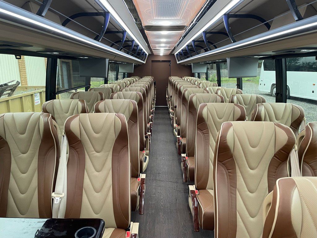 The inside of a bus with a lot of seats and a table.