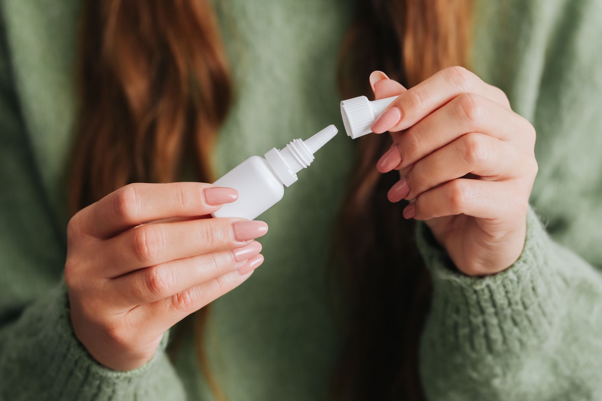 woman using nasal spray 