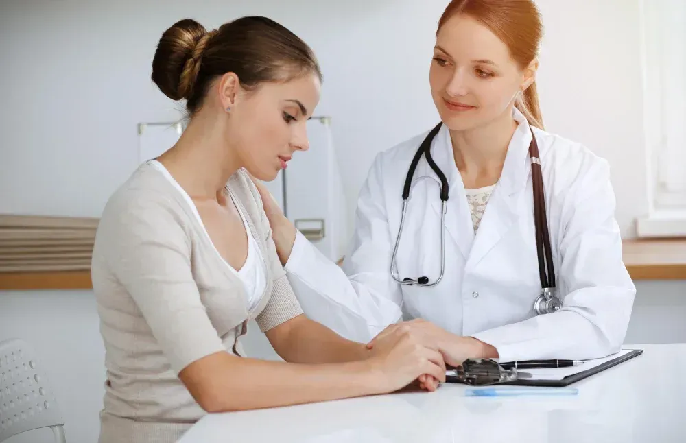 Expecting couple meeting with a fertility specialist at Precision IVF in Dallas