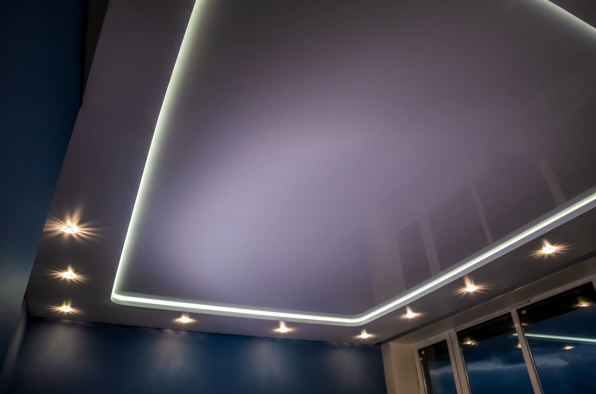 Beautiful stretch ceiling showcasing LED lighting installation with projectors around perimeter.