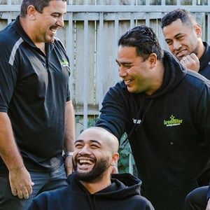 A group of men are standing next to each other and laughing.