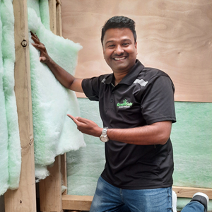 A man in a black shirt with a green logo on it