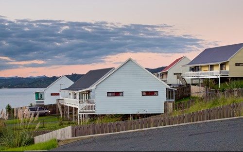 A row of houses with a lake in the background