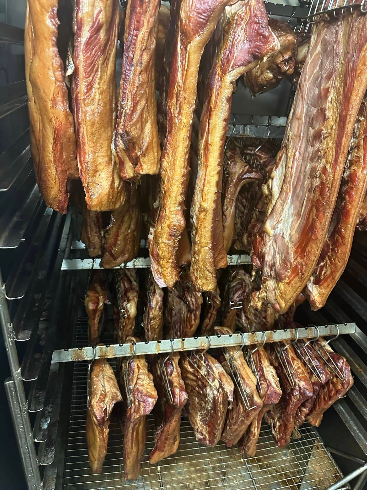 bacon hanging in smoker