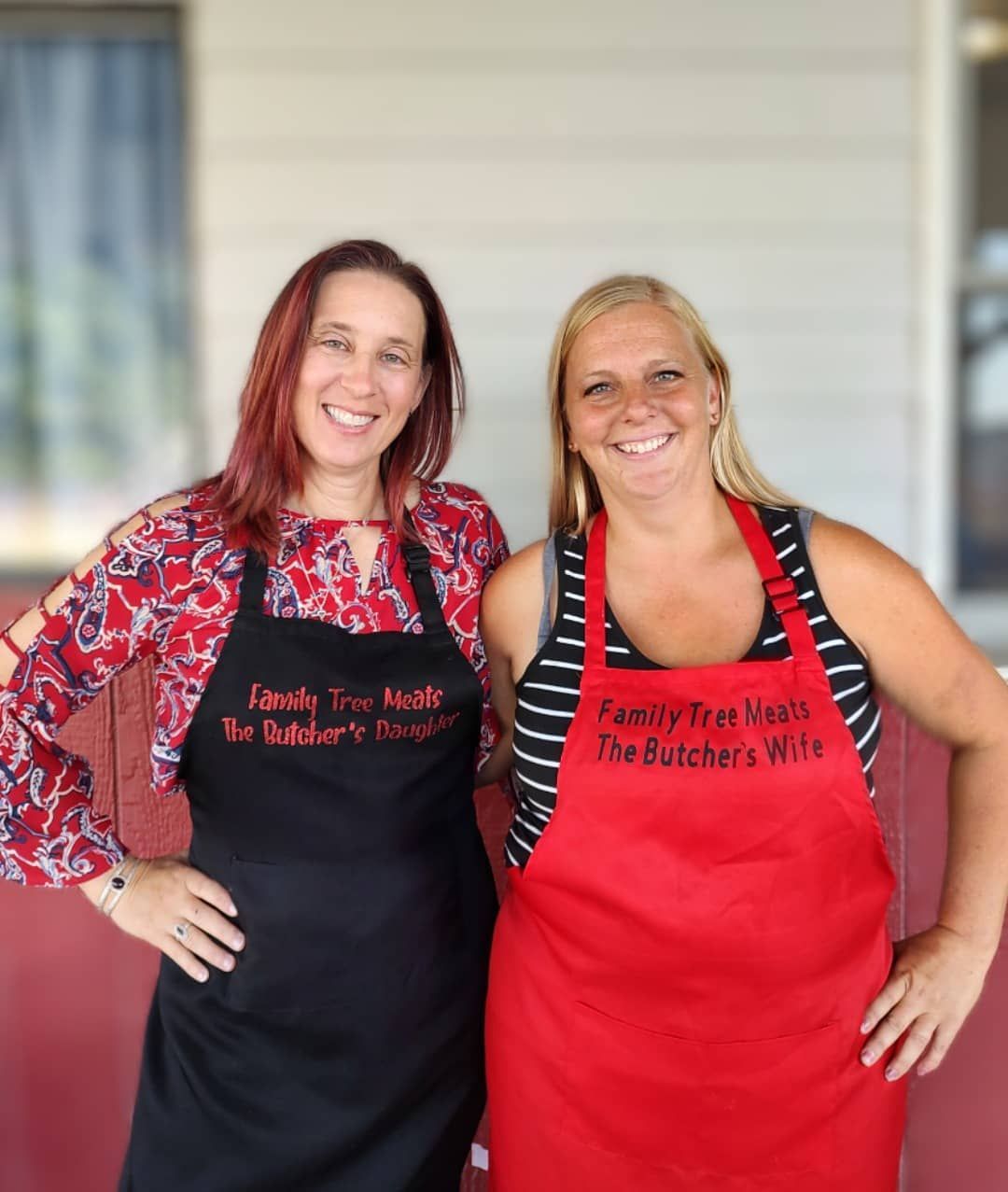 the butcher's wives. 2 ladies wearing aprons.