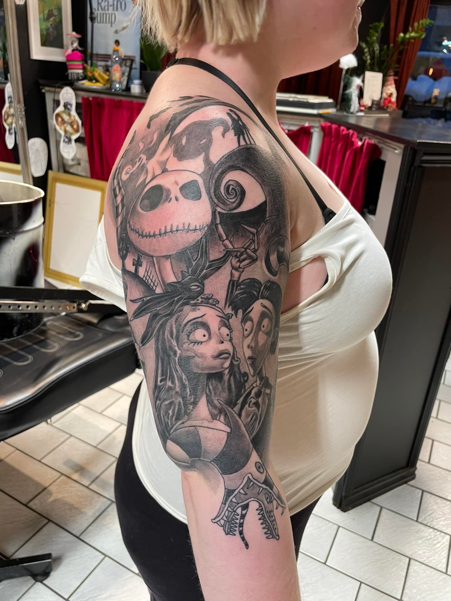 Detaljert black & grey tatovering inspirert av Tim Burton-filmer,  Nightmare Before Christmas og Corpse Bride – på overarm