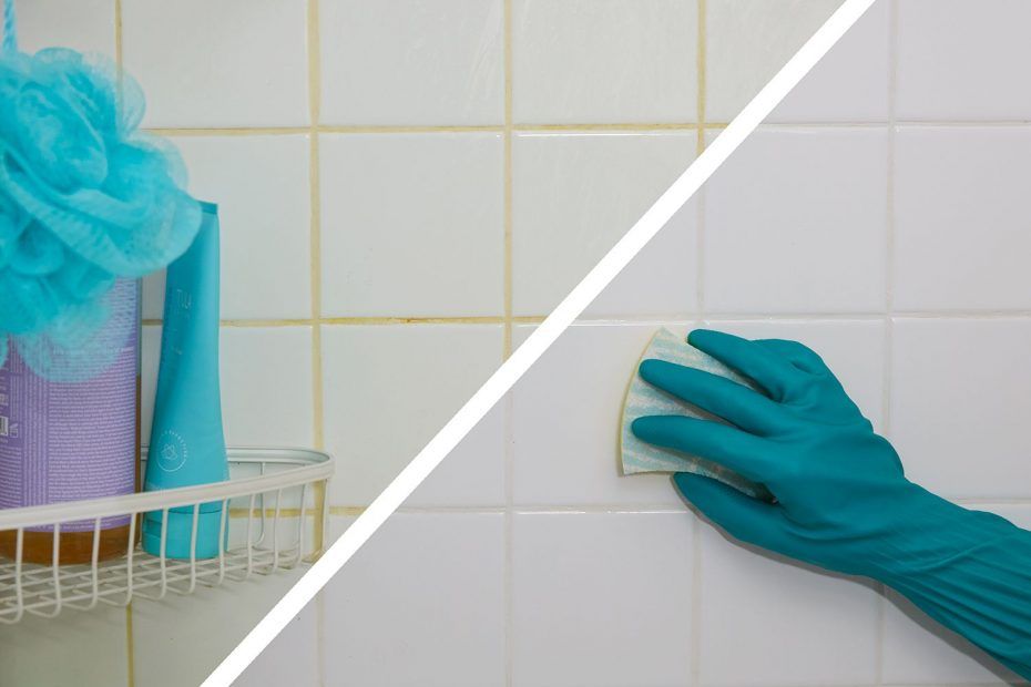 a person is cleaning a bathroom wall with a sponge .