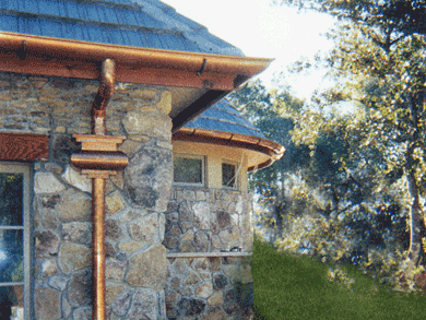 A close up of a gutter on the roof of a house.