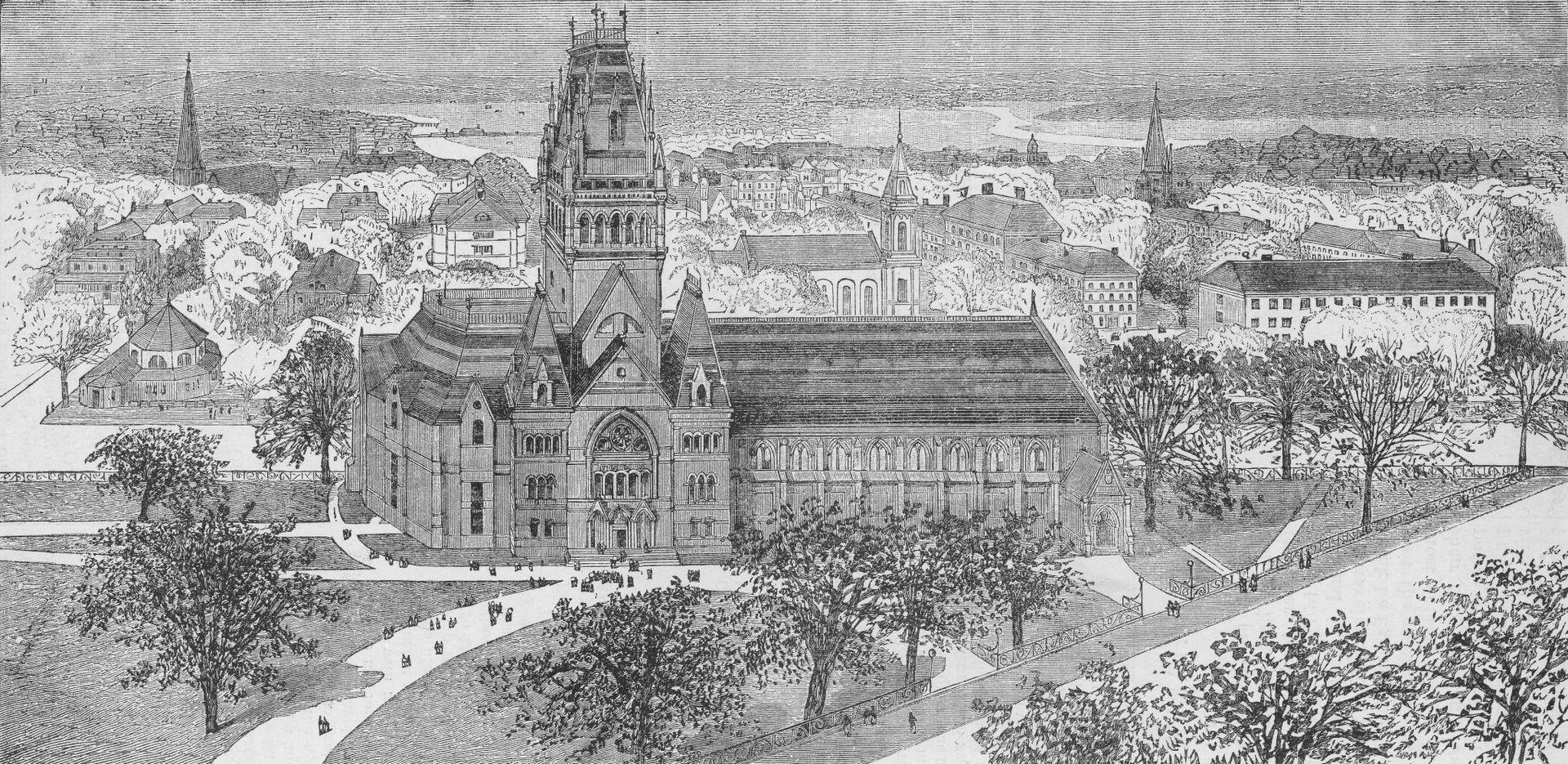 Historic cityscape with a tall central clock tower, surrounding buildings, and a river in the foreground