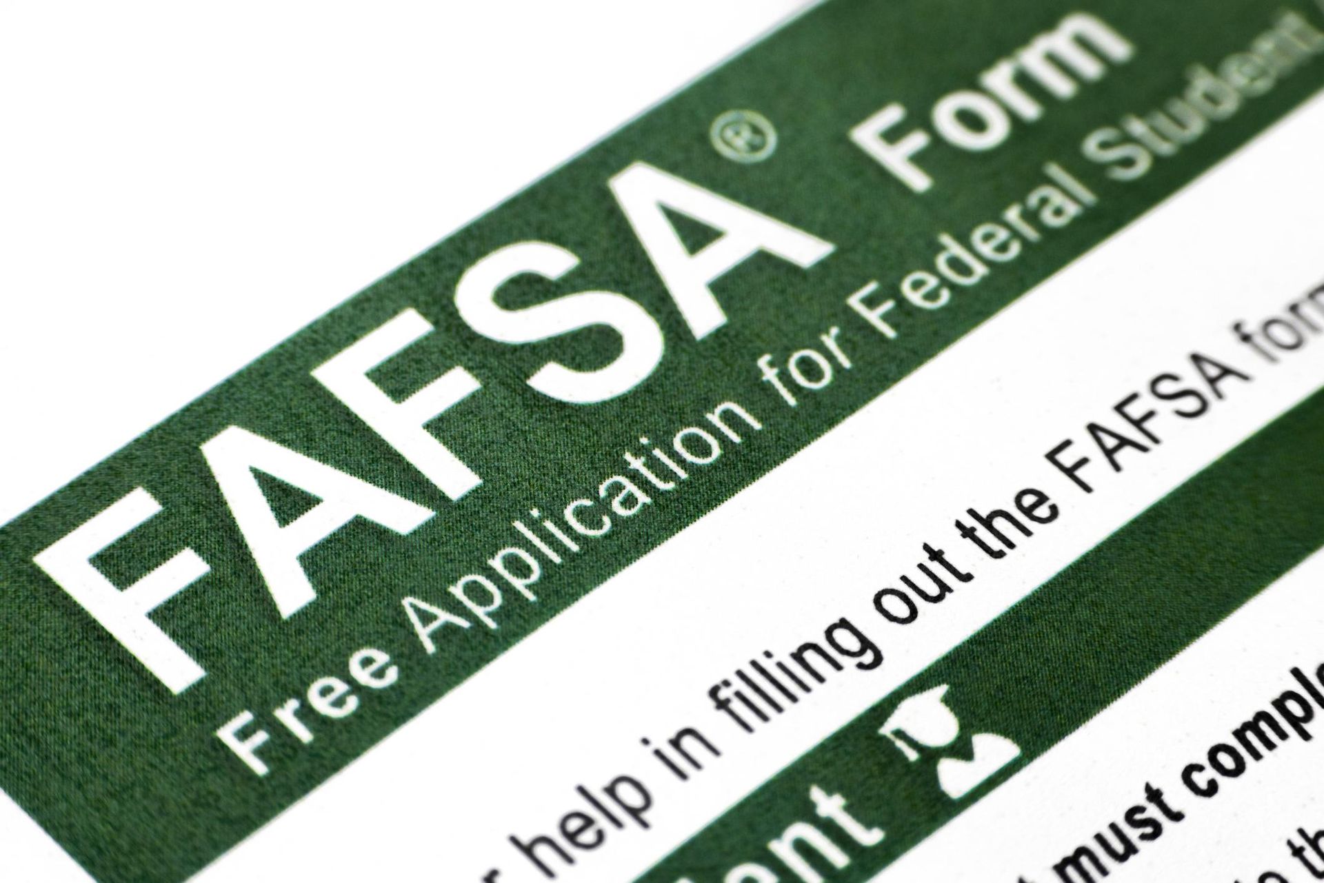 Close-up of a green FAFSA form with white text for federal student aid