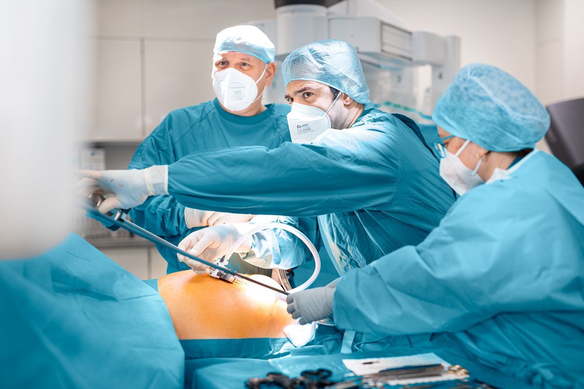 Eine Gruppe von Chirurgen führt in einem Operationssaal eine Operation an einem Patienten durch.