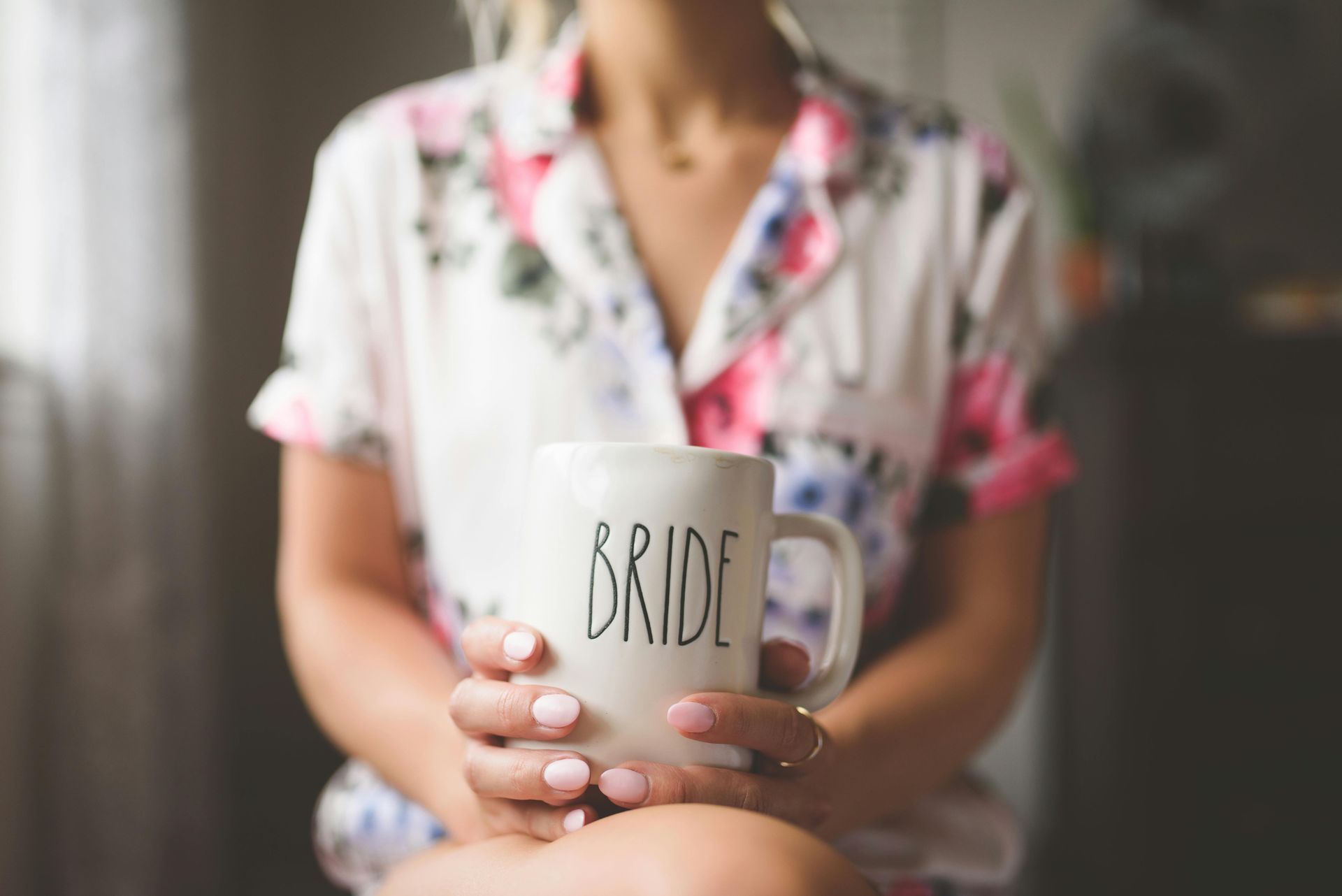 Woman in floral pajamas holding a 