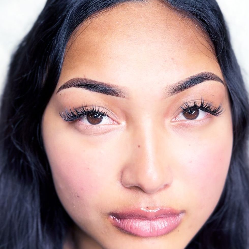 A close up of a woman 's face after a microblading treatment.