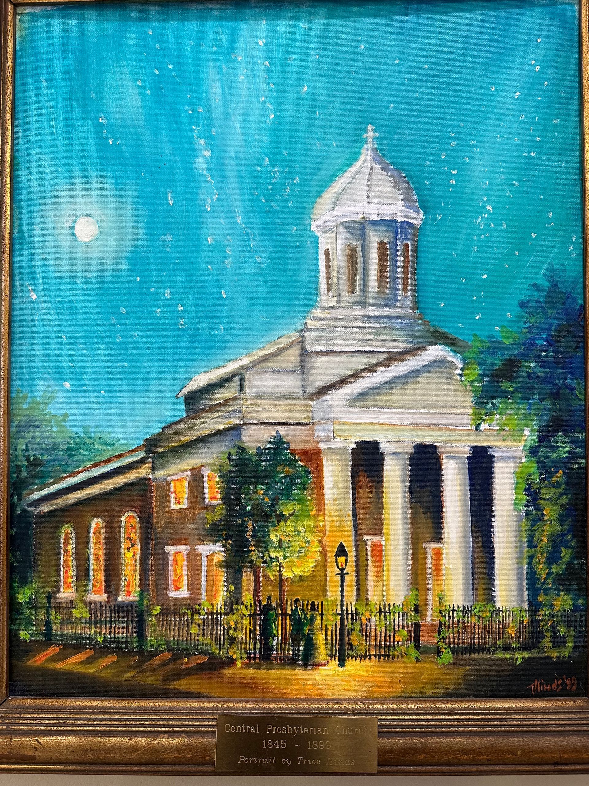 Watercolor of a historic white-columned building under a bright blue sky, framed in a black display case.