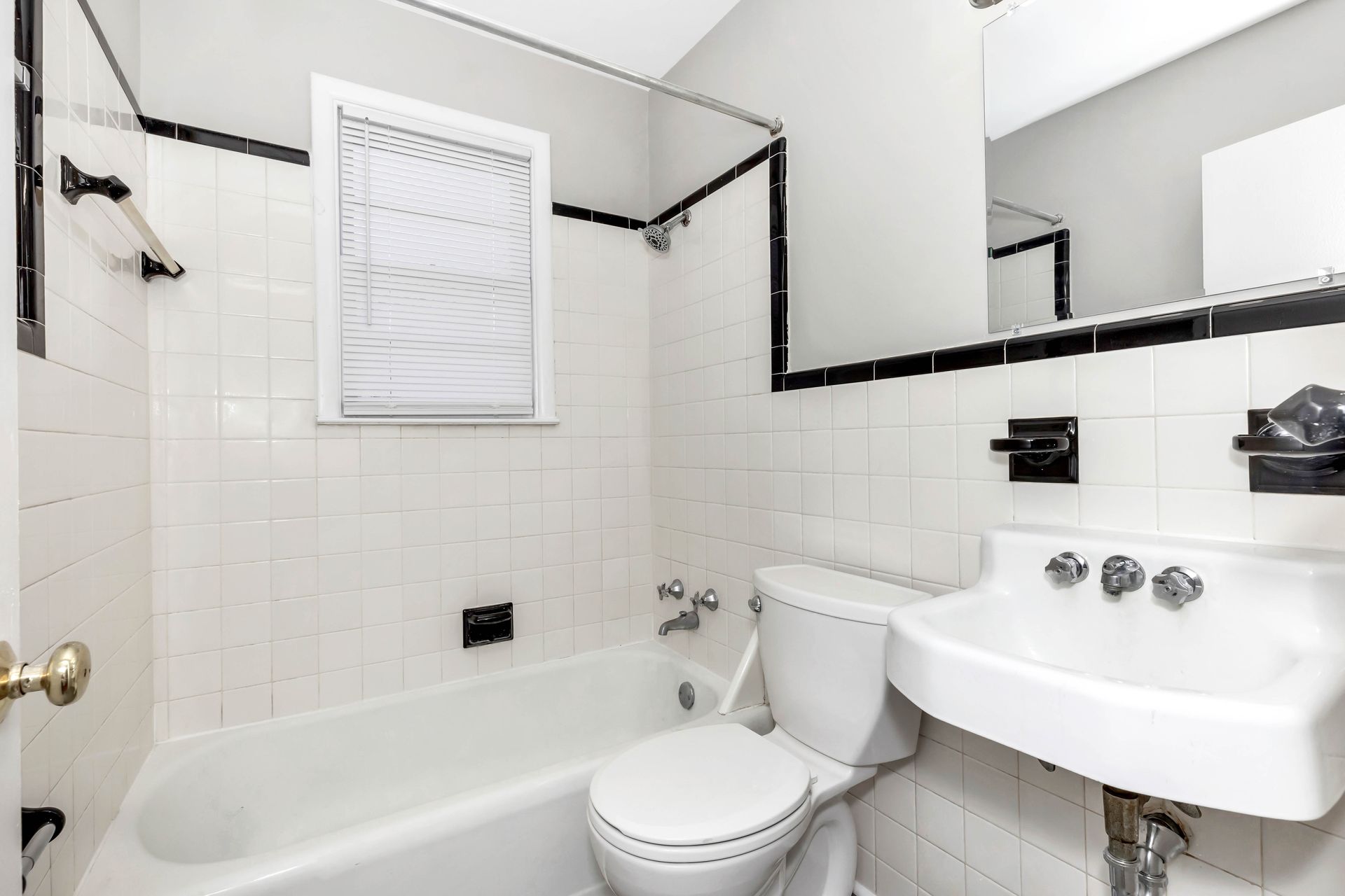 A bathroom with a toilet , sink and bathtub
