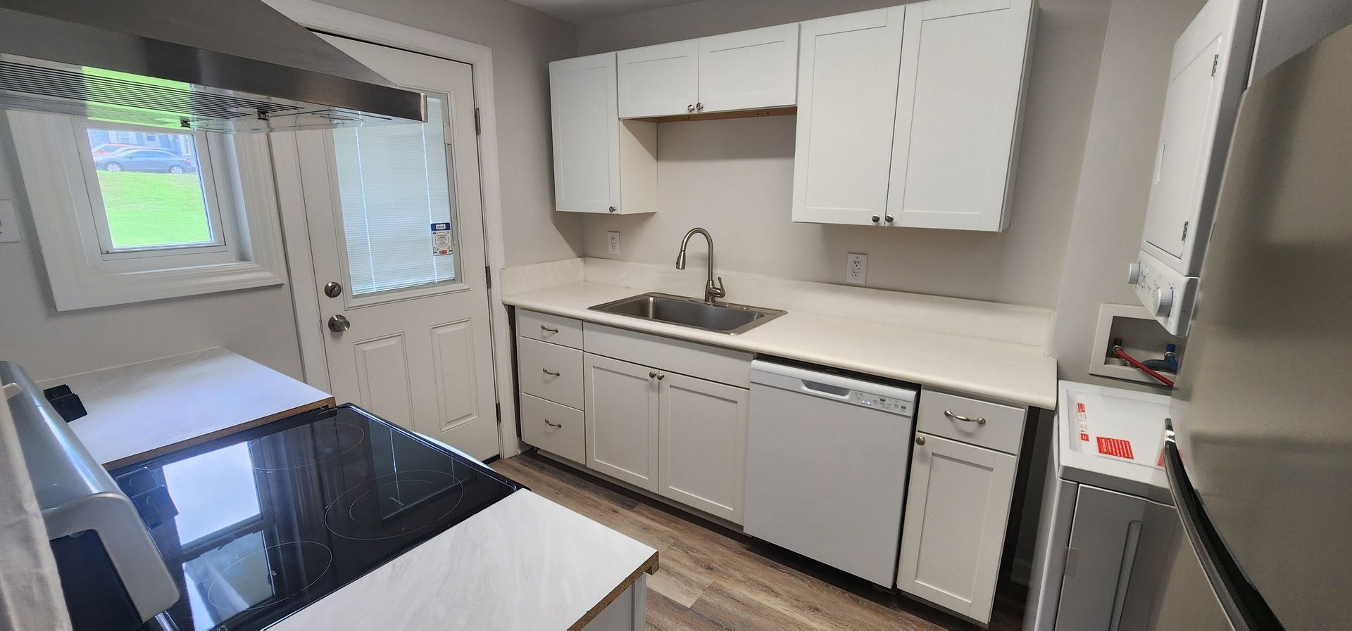 A kitchen with white cabinets and stainless steel appliances.