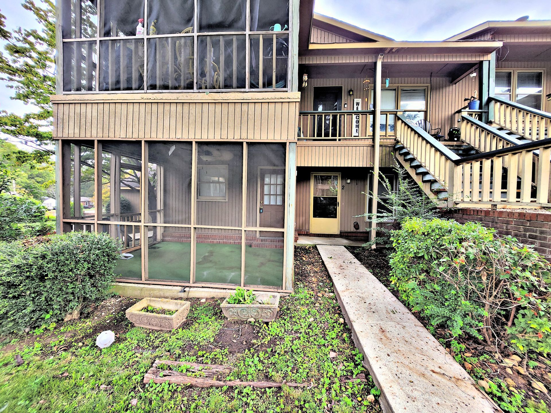 A house with a screened in porch and stairs