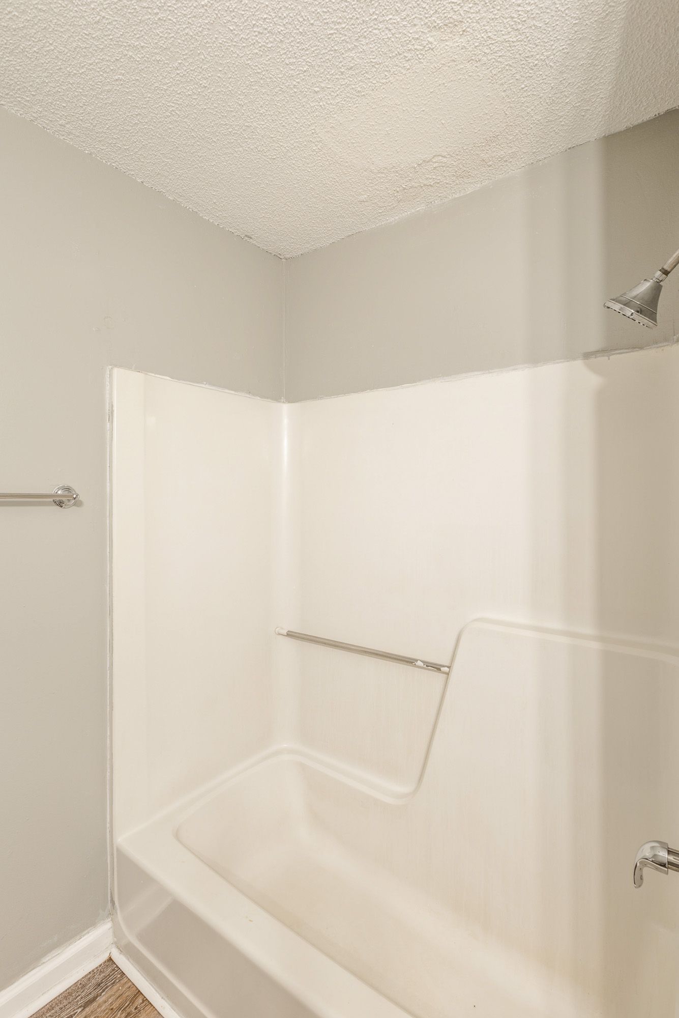 A bathroom with a bathtub and a shower.