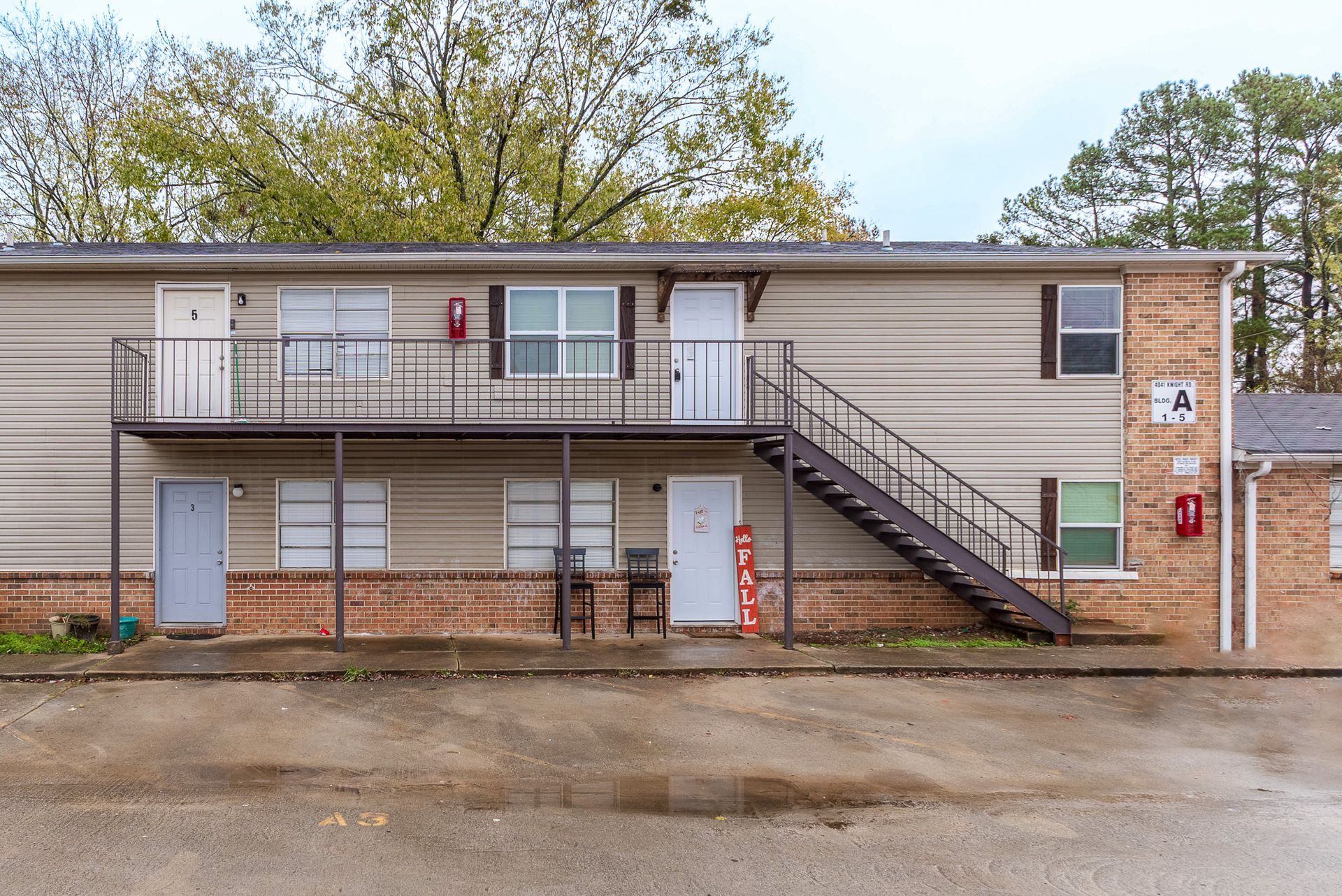 A small apartment building with stairs leading up to the second floor