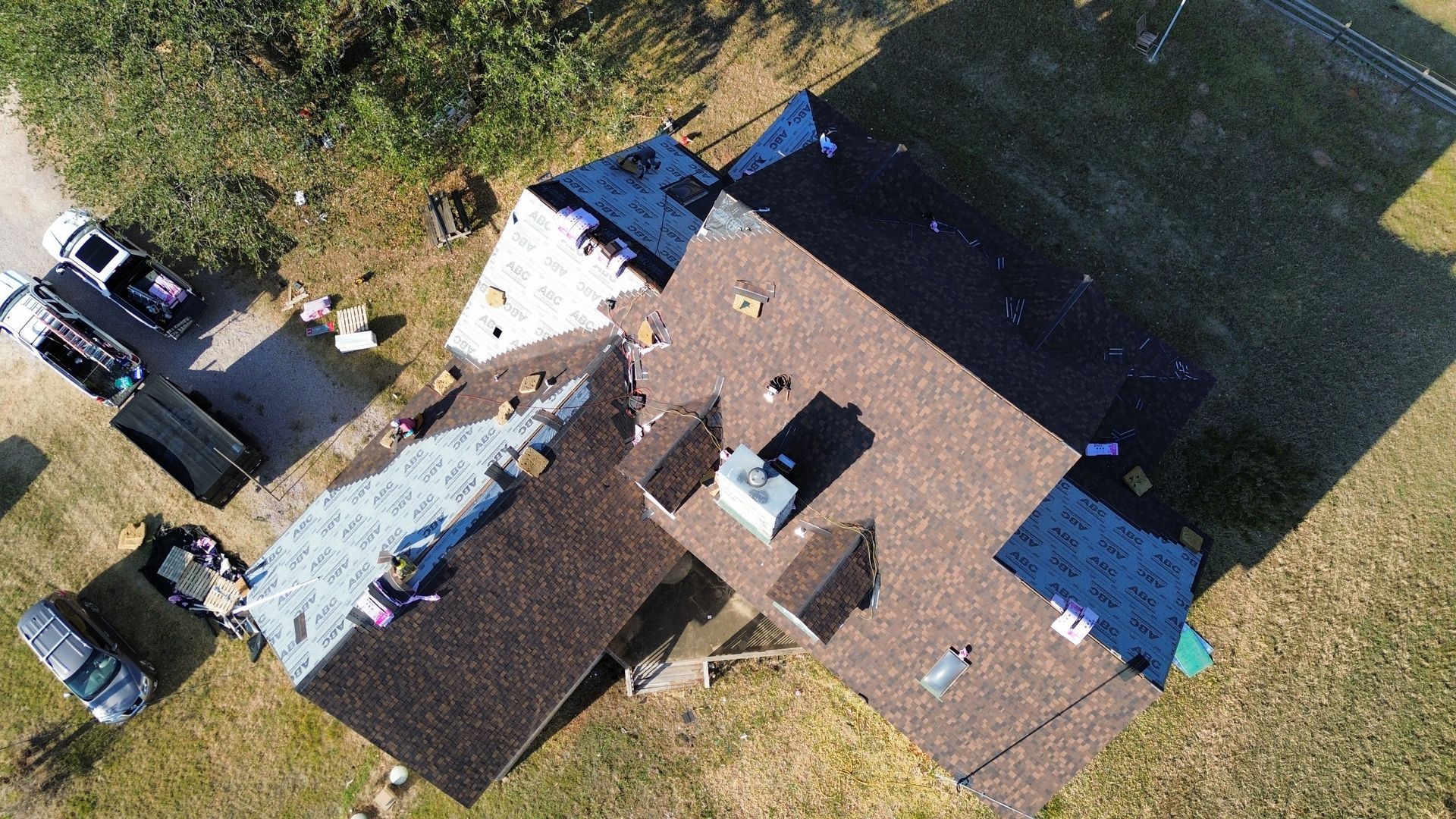 An aerial view of a house with a roof being installed.