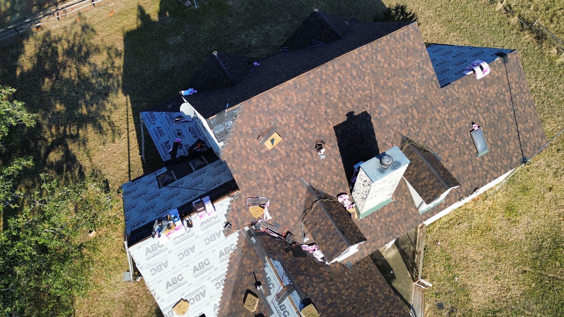 An aerial view of a roof being installed on a house.