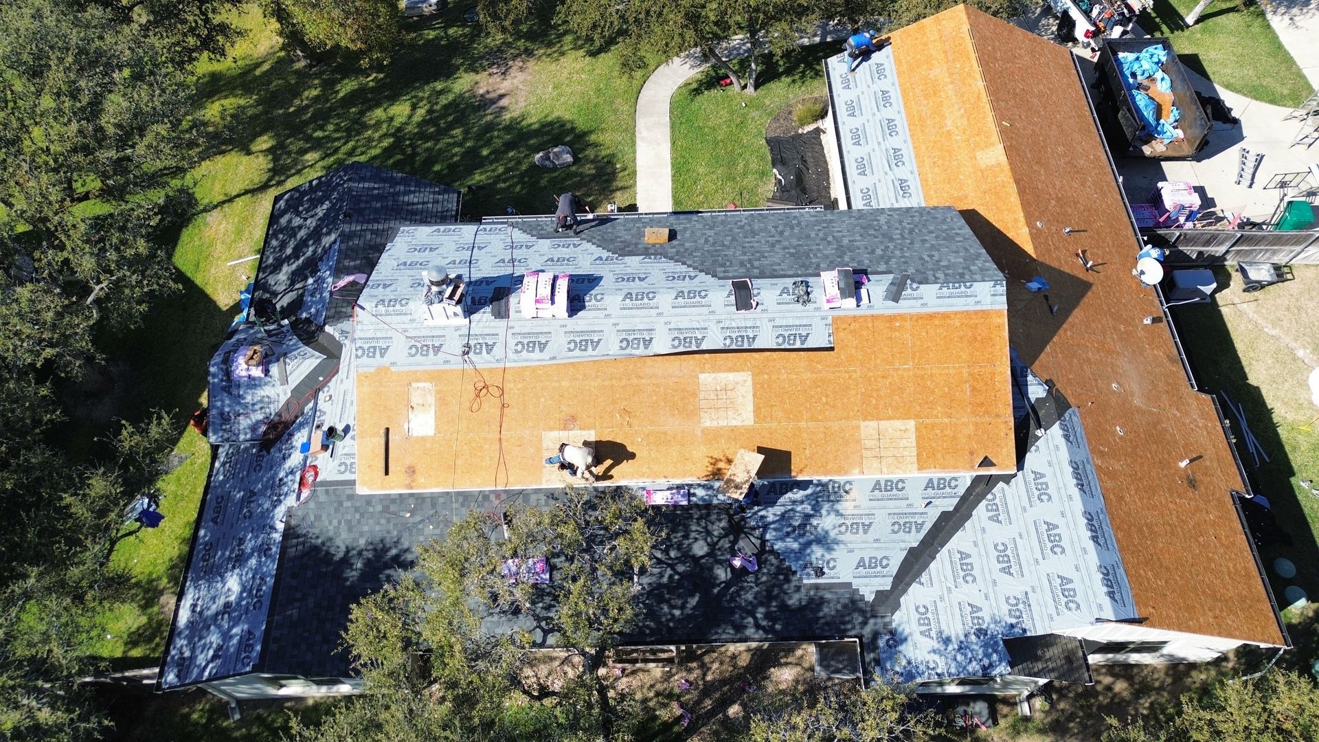An aerial view of a house with a roof being installed.