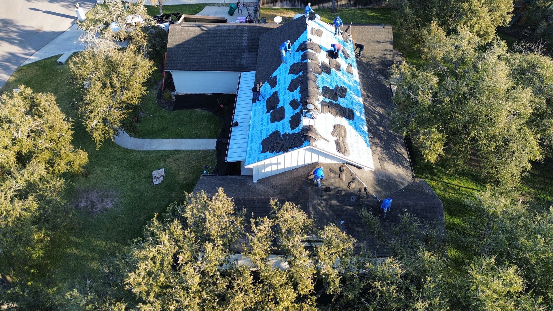 An aerial view of a house with a roof being installed.